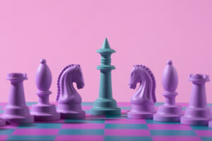 Purple and green chess figures on the pink background. Article title: playing chess with a computer.